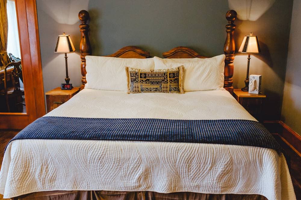 The king bed is welcoming in this bedroom right at the top of the stairs