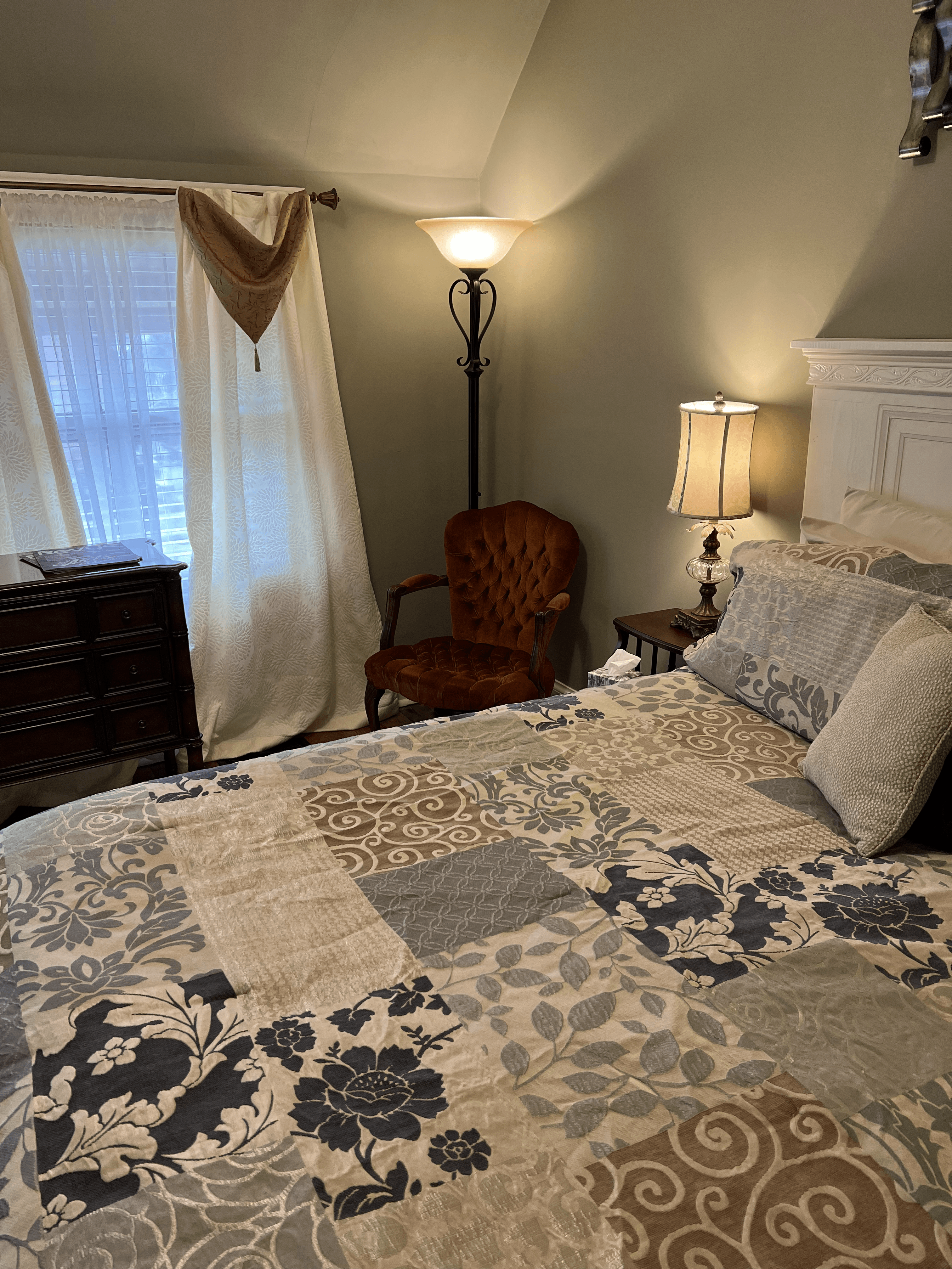 Small reading area between the large window and king bed