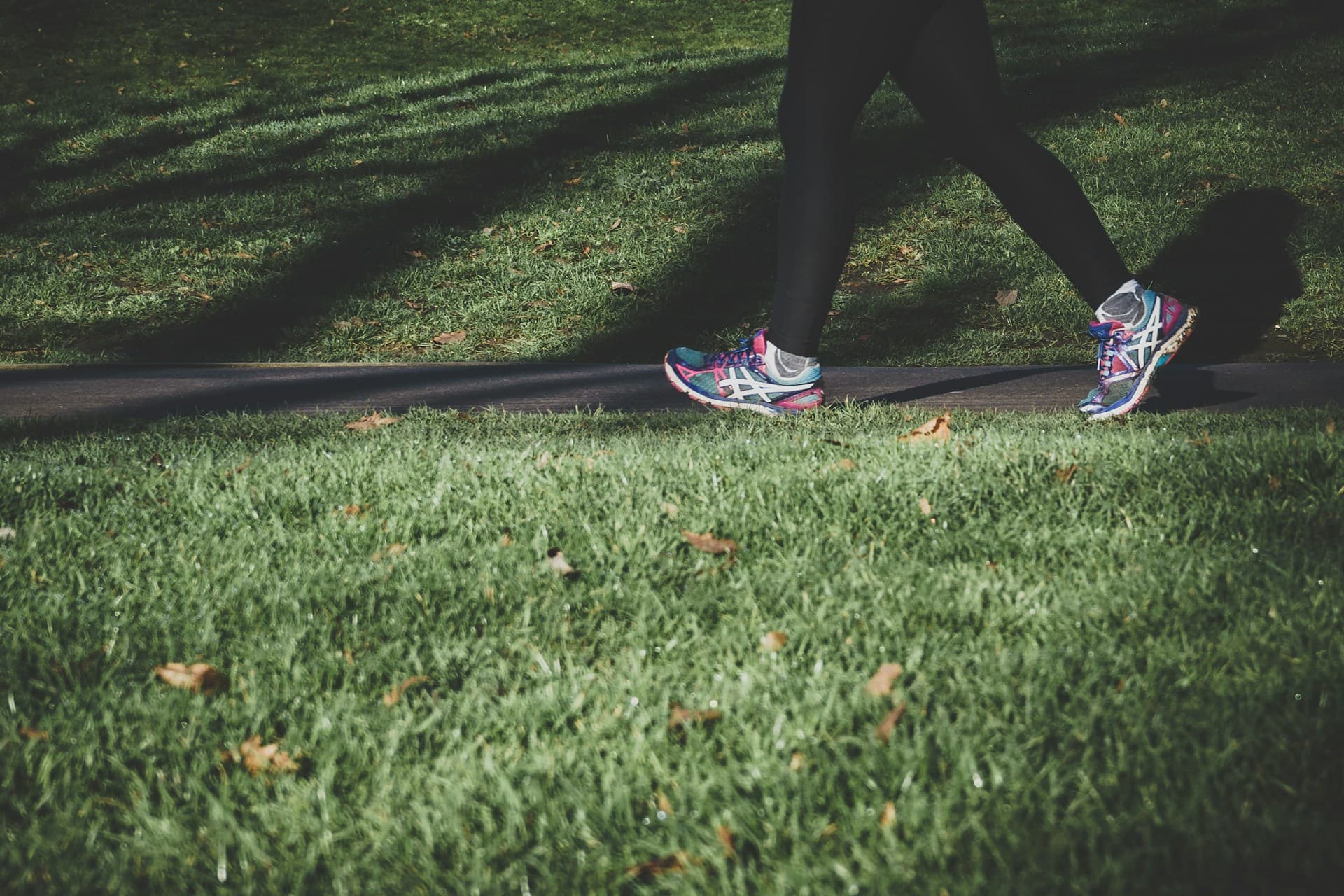 Closeup of a person walking in an urban park